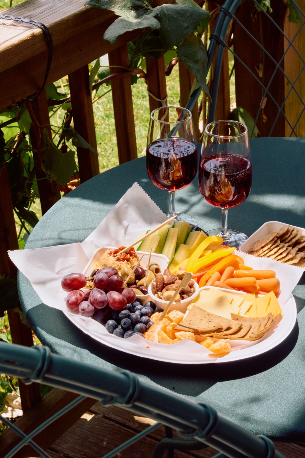 Wine and a charcuterie board on the deck at Le Petit Chevalier